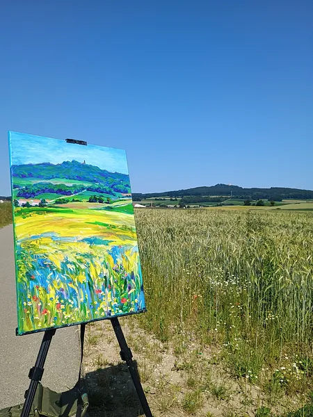 Image of Blick auf den Bussen aus einem blühenden Weizenfeld by Karina Semenyuk, size: 50 x 70, made of Oil on canvas, Paintings medium, from Unlingen, Germany, part of the Summer 2025 series, priced at €380